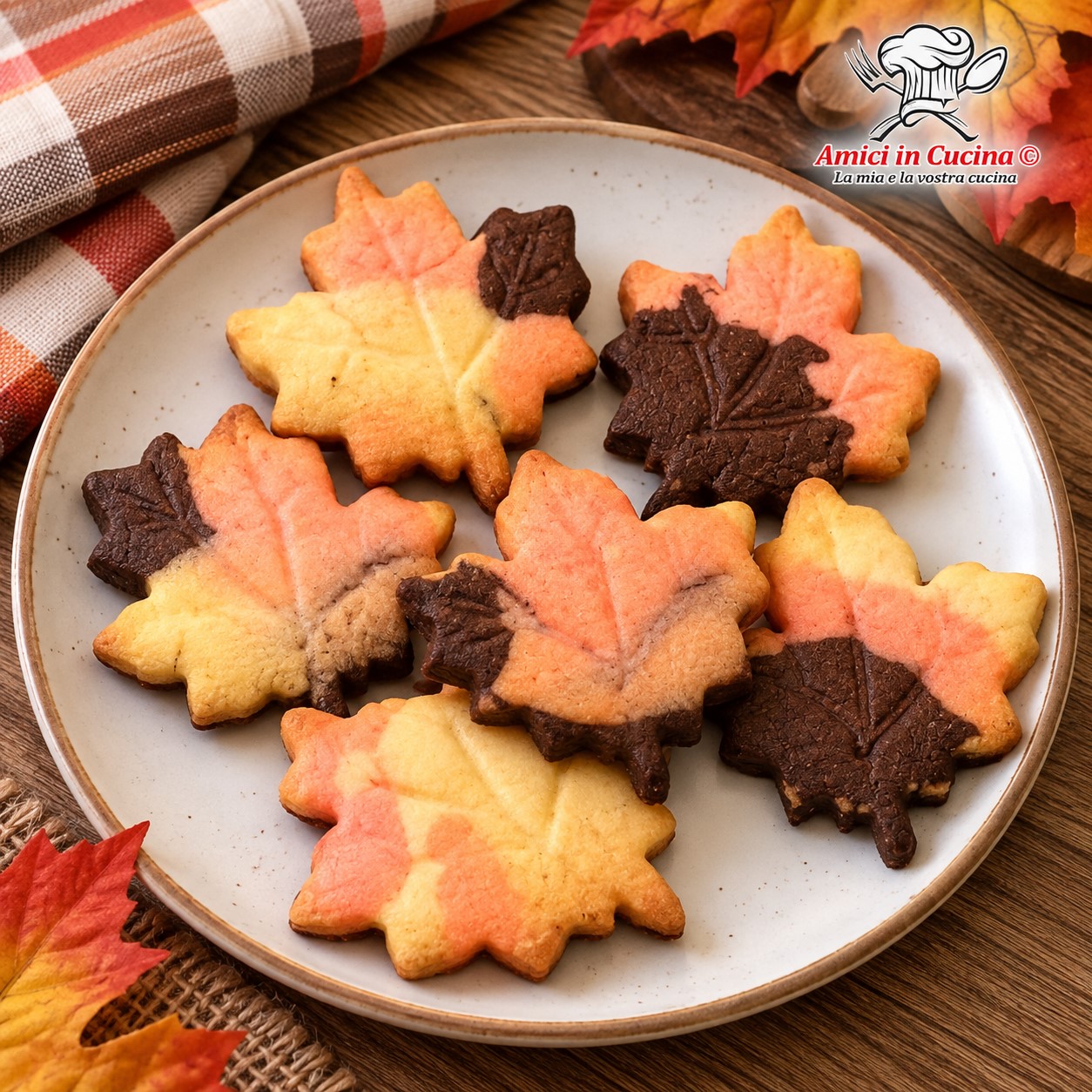 Biscotti di pasta frolla a forma di foglia nei tre colori autunnali cacao alchermes e vaniglia preparati da Jenny D'Andrea