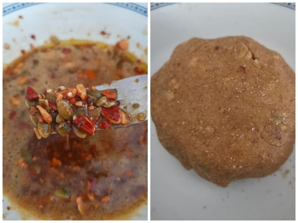 Preparazione dell'impasto per i biscotti integrali con un focus sul mix di semi di zucca e mandorle sollevato con una forchetta.