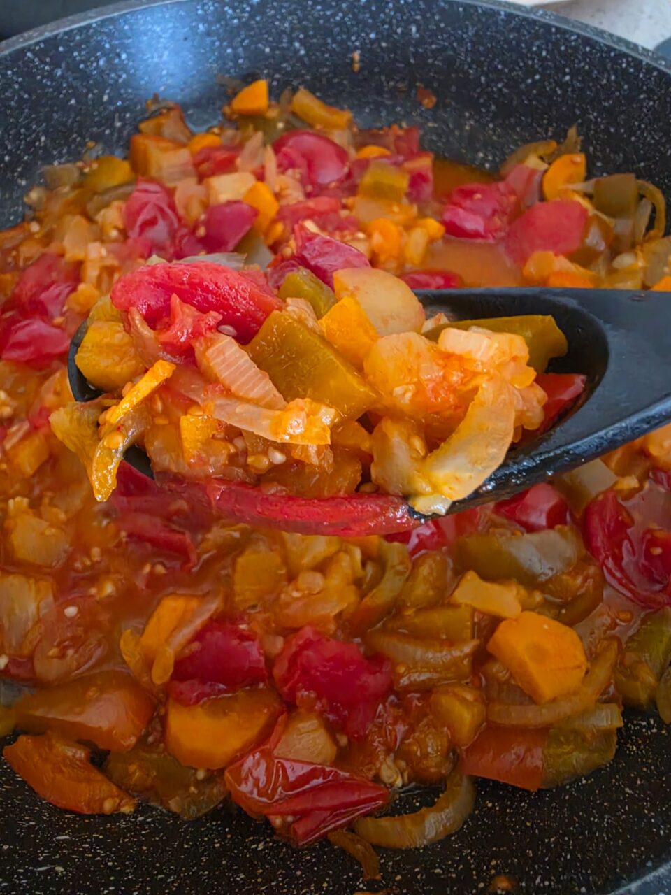 Mestolo con il sugo di verdure stive in padella ben cotto e pronto da gustare