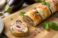 Rotolo di melanzane con speck e scamorza – Filante e saporito
