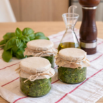 Pesto al basilico fatto in casa cremoso in ciotola con foglie fresche