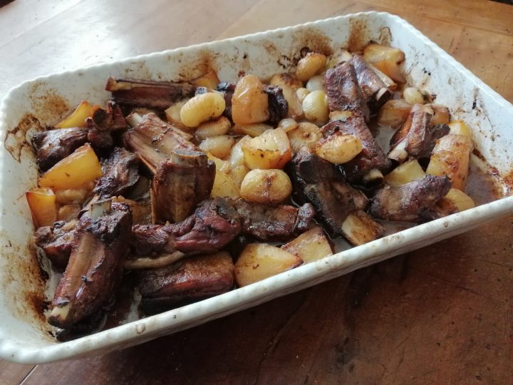 Costine di maiale al forno con patate e cipolline