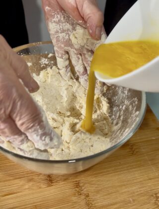 Preparazione dei frascarelli con farina e uova in ciotola