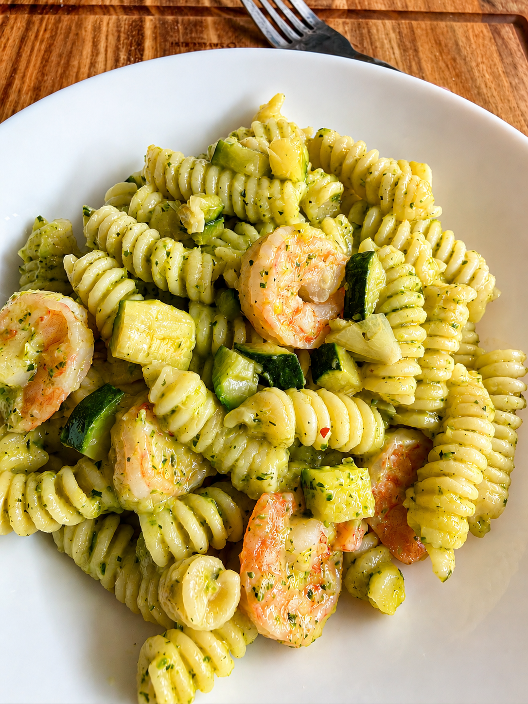 Pasta cremosa con zucchine e mazzancolle servita con crema di zucchine e cubetti di zucchina croccanti