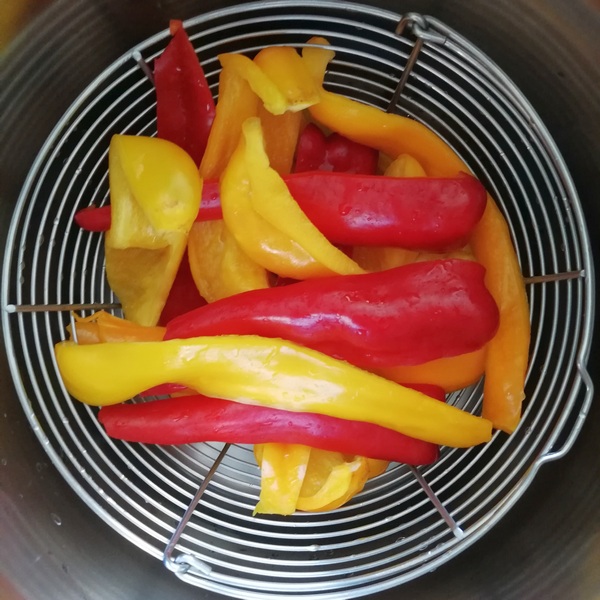 peperoni rossi e gialli in cestello pentola a pressione