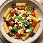 Pasta fredda con melanzane, pomodorini e primo sale