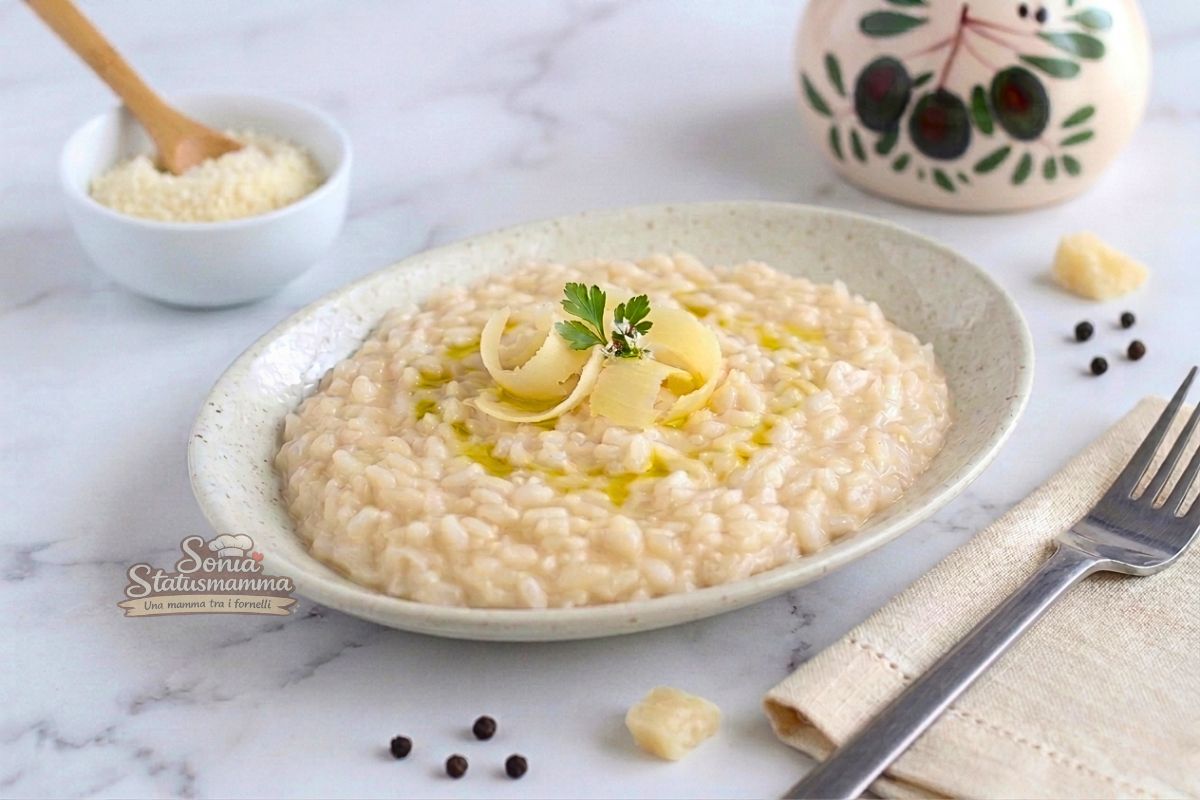 Un piatto ovale di cremoso risotto al parmigiano.scattp orizzontale jpg